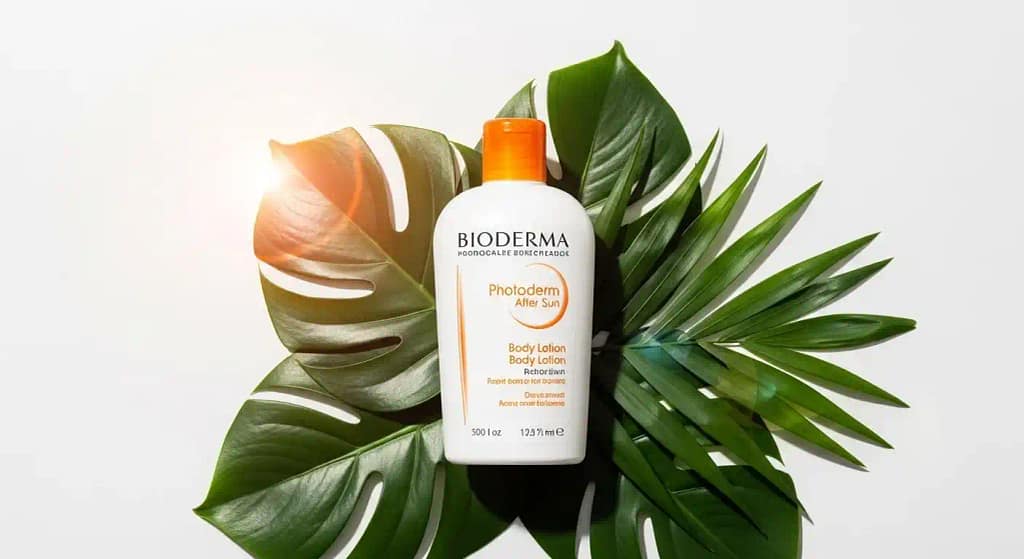 Bioderma Photoderm Aftersun Body Lotion Soothing Moisturiser for Face bottle with tropical background